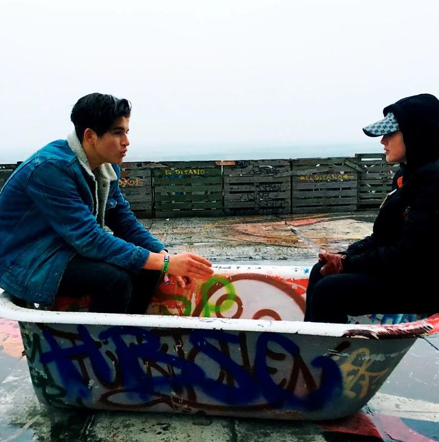 Two teenagers sitting in a graffiti-covered bathtub on the roof of Teufelsberg, Berlin, during the first Y_Space workshop
